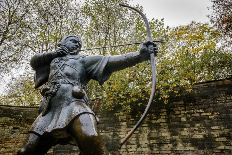 A statue of a man holding a bow and arrow