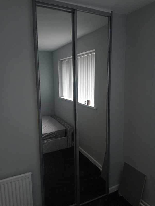 Fitted sliding wardrobe in bedroom