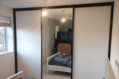 Mirrored wardrobe with two white panel sections