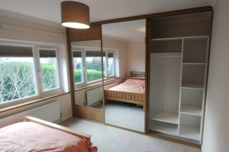 mirrored wardrobe in cream bedroom right door open