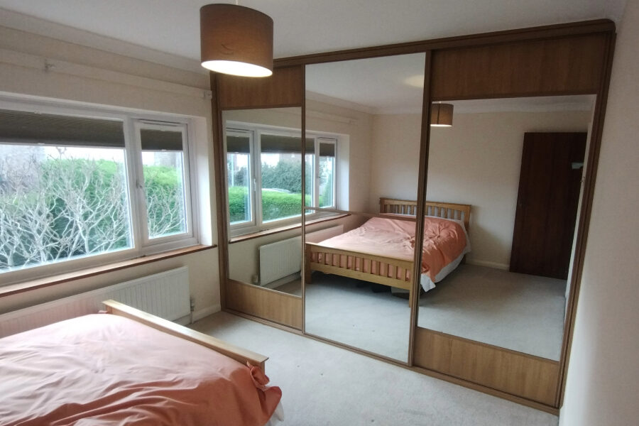 mirrored wardrobe in cream bedroom, closed