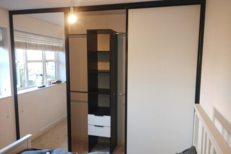 Mirrored wardrobe with two sections open