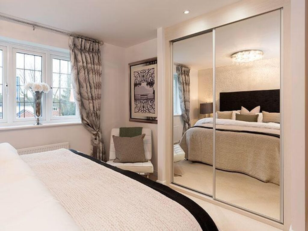 A stylish bedroom with a two-door mirror sliding wardrobe, creating an illusion of more space.